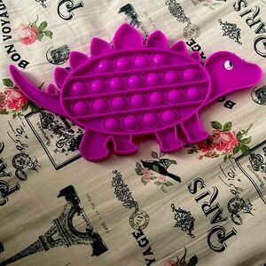 Purple pop it dinosaur
